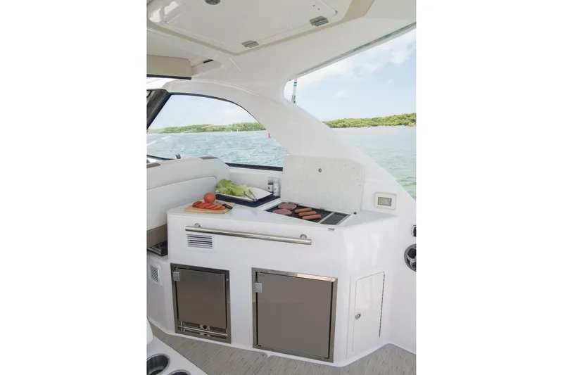 Slide: The Image of Manufacturer Provided Image: 2017 Regal 35 Sport Coupe yacht interior with a built-in grill and storage. - 8