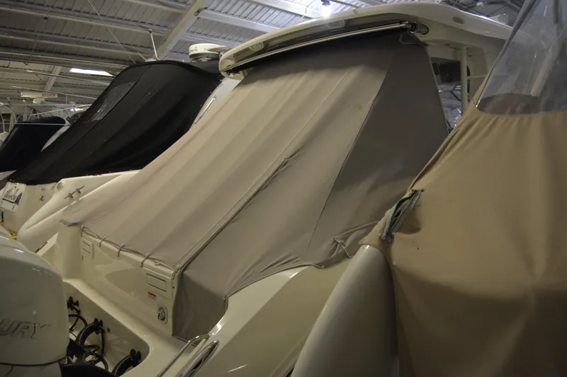Slide: The Image of 2019 Boston Whaler 350 Realm with protective cover in a storage facility. - 17