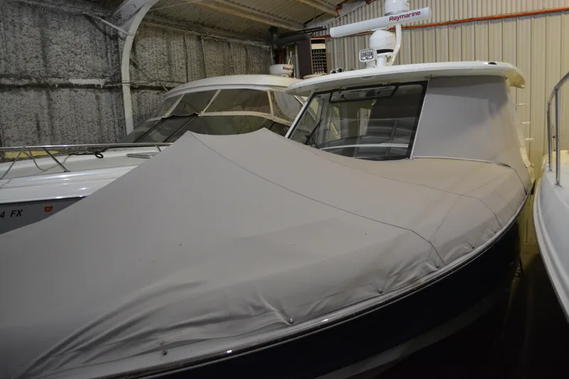 Slide: The Image of 2019 Boston Whaler 350 Realm boat with cover in storage. - 19