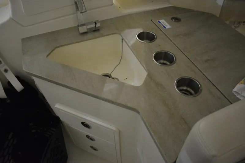 Slide: The Image of Interior of 2019 Boston Whaler 350 Realm with anchor-patterned rug and storage compartment. - 29