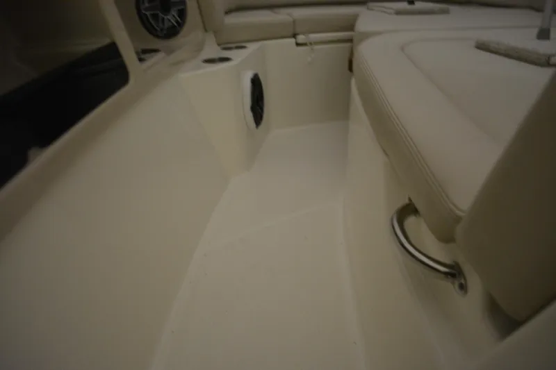 Slide: The Image of 2019 Boston Whaler 350 Realm interior with beige seating and cup holders. - 38