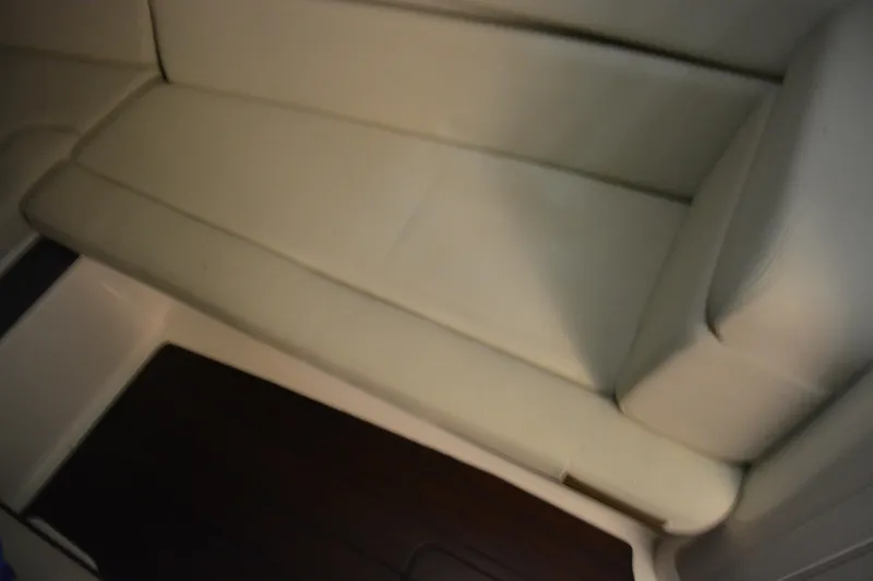 Slide: The Image of Interior of 2019 Boston Whaler 350 Realm, featuring beige seating and wooden paneling. - 47