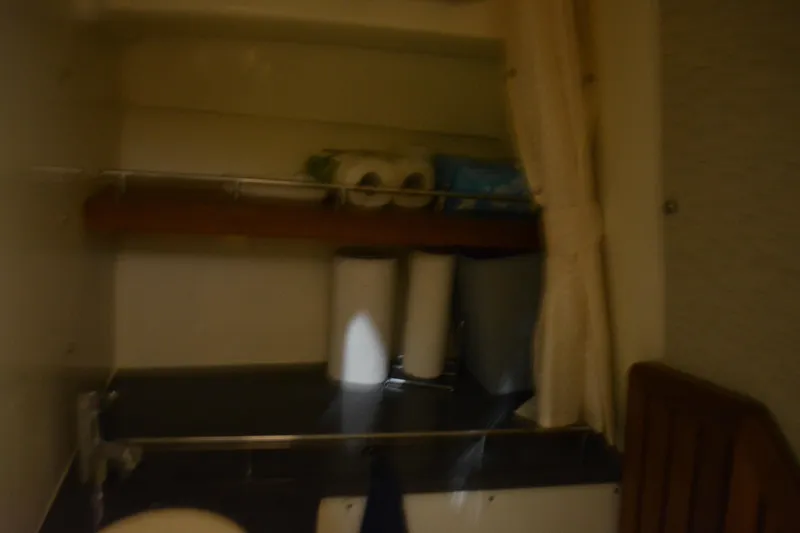 Slide: The Image of 2019 Boston Whaler 350 Realm boat bathroom with sink and toilet. - 51