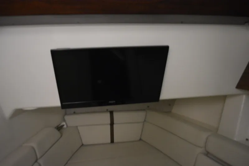 Slide: The Image of Interior of 2019 Boston Whaler 350 Realm with TV and cushioned seating. - 58