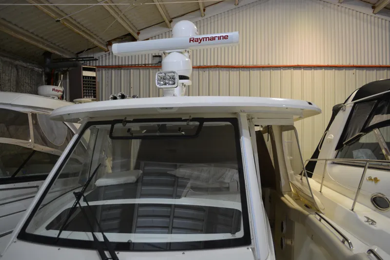 Slide: The Image of 2019 Boston Whaler 350 Realm boat with Raymarine radar in a storage facility. - 60