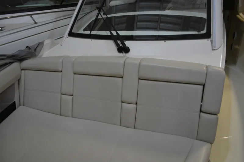Slide: The Image of 2019 Boston Whaler 350 Realm boat interior with beige seating and windshield. - 61