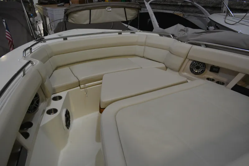 Slide: The Image of 2019 Boston Whaler 350 Realm boat interior with cushioned seating and cup holders. - 63