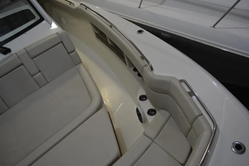 Slide: The Image of 2019 Boston Whaler 350 Realm boat interior with cushioned seating and stainless steel accents. - 66