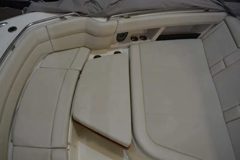 Slide: The Image of 2019 Boston Whaler 350 Realm boat interior with white cushioned seating. - 68