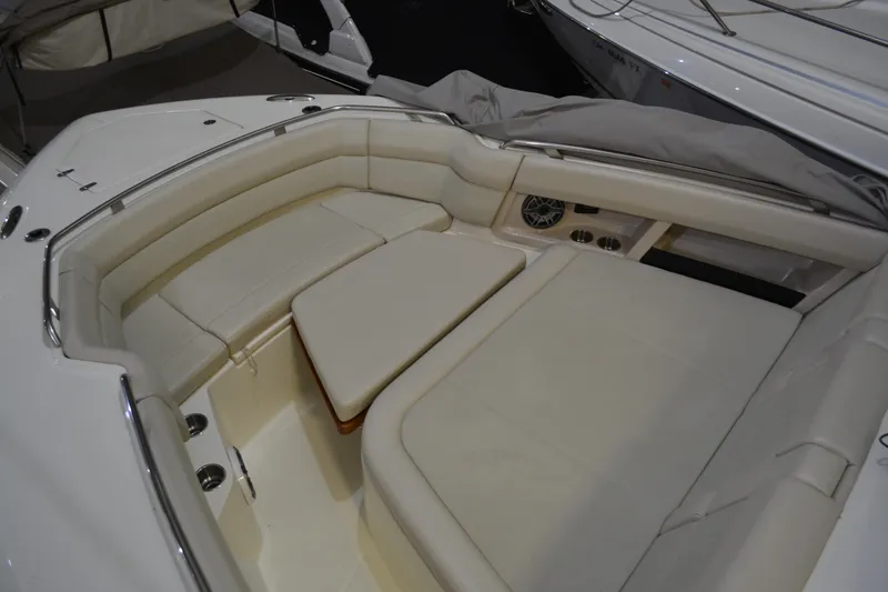 Slide: The Image of 2019 Boston Whaler 350 Realm boat interior with cushioned seating and table. - 70