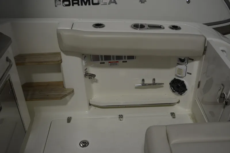Slide: The Image of 2019 Boston Whaler 350 Realm boat interior with seating, steps, and control panel. - 74