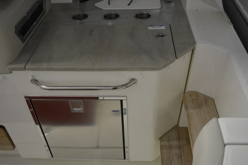 Slide: The Image of 2019 Boston Whaler 350 Realm boat interior with stainless steel kitchenette and storage. - 75