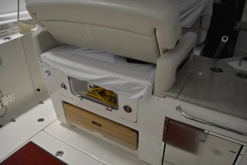 Slide: The Image of Interior of 2019 Boston Whaler 350 Realm, featuring seating and storage compartments. - 77