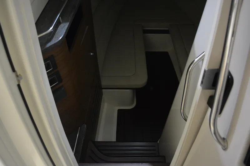 Slide: The Image of Interior cabin of 2019 Boston Whaler 350 Realm, featuring seating and compact design. - 85