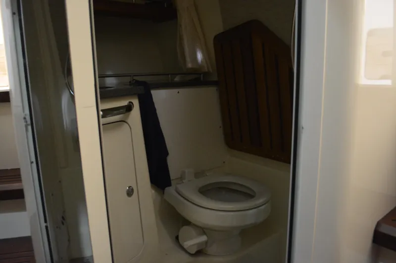 Slide: The Image of Interior view of 2019 Boston Whaler 350 Realm boat bathroom with toilet and storage. - 86