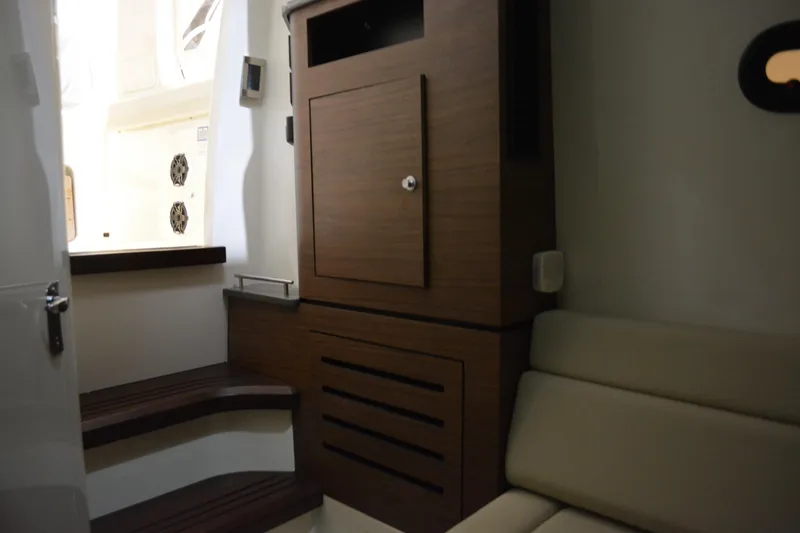 Slide: The Image of Interior of 2019 Boston Whaler 350 Realm, featuring wooden cabinetry and seating. - 88