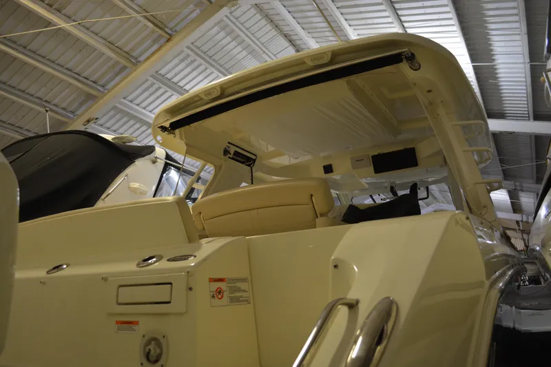 Slide: The Image of 2019 Boston Whaler 350 Realm boat interior in a storage facility. - 90