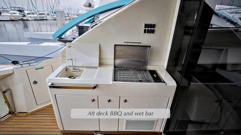 Slide: The Image of Aft deck BBQ and wet bar on 2013 Marquis 500 Sport Bridge yacht. - 12