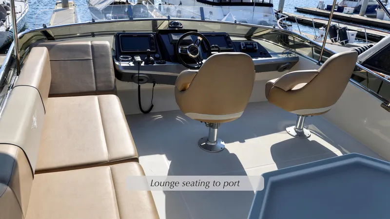 Slide: The Image of 2013 Marquis 500 Sport Bridge interior with helm and lounge seating. - 8