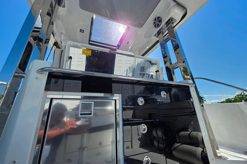 Slide: The Image of 2021 Jeanneau Leader 10.5 WA boat interior with sleek kitchen and seating area. - 24