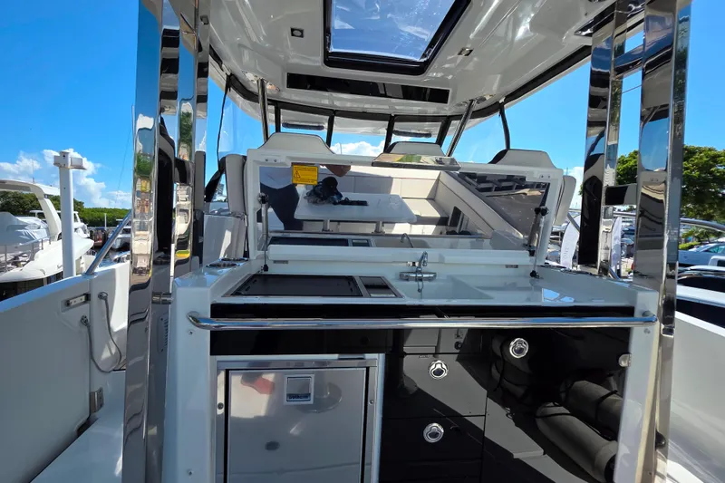 Slide: The Image of 2021 Jeanneau Leader 10.5 WA cockpit with modern seating and navigation equipment. - 25