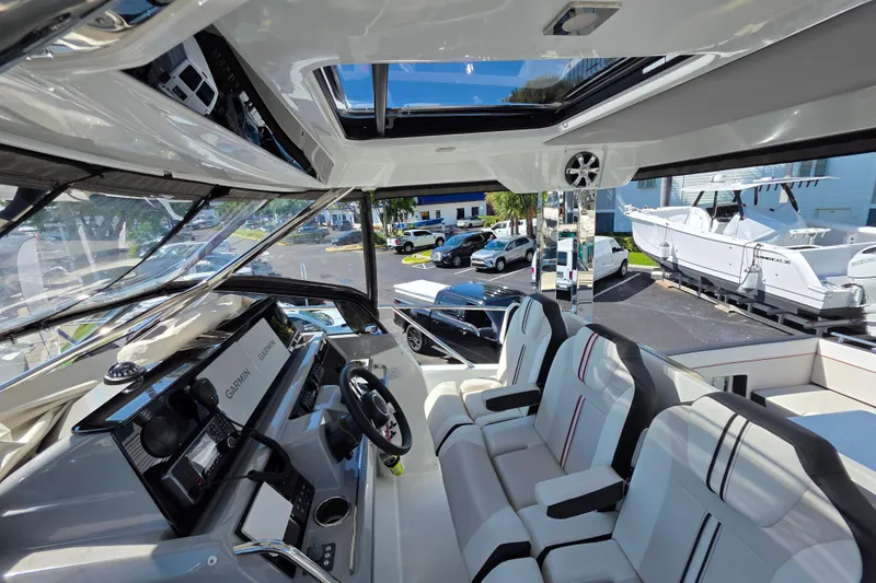 Slide: The Image of 2021 Jeanneau Leader 10.5 WA boat interior with modern cockpit and Garmin navigation systems. - 27