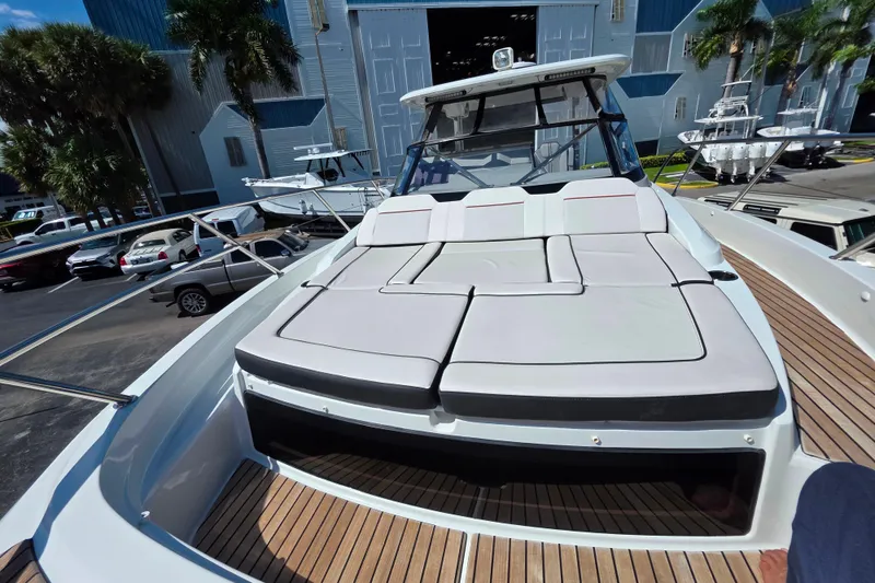 Slide: The Image of 2021 Jeanneau Leader 10.5 WA boat with spacious sunbathing deck in marina setting. - 33