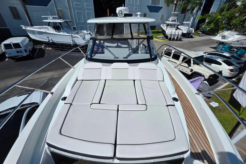 Slide: The Image of 2021 Jeanneau Leader 10.5 WA boat with sun deck, docked near a marina. - 34