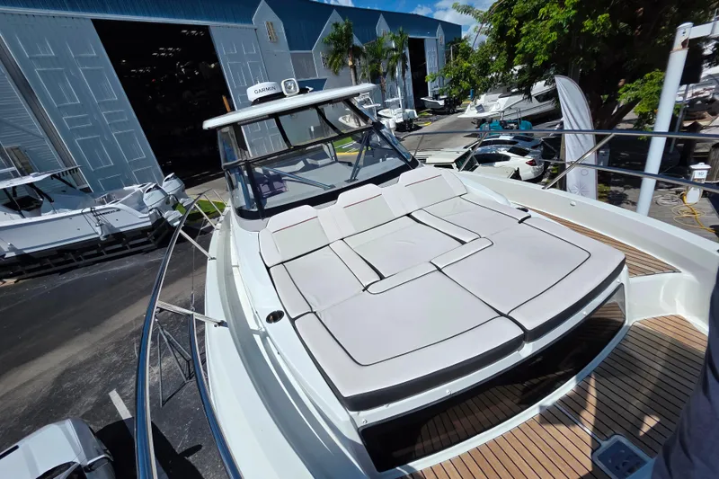 Slide: The Image of 2021 Jeanneau Leader 10.5 WA boat with sleek design and wooden deck under blue sky. - 35