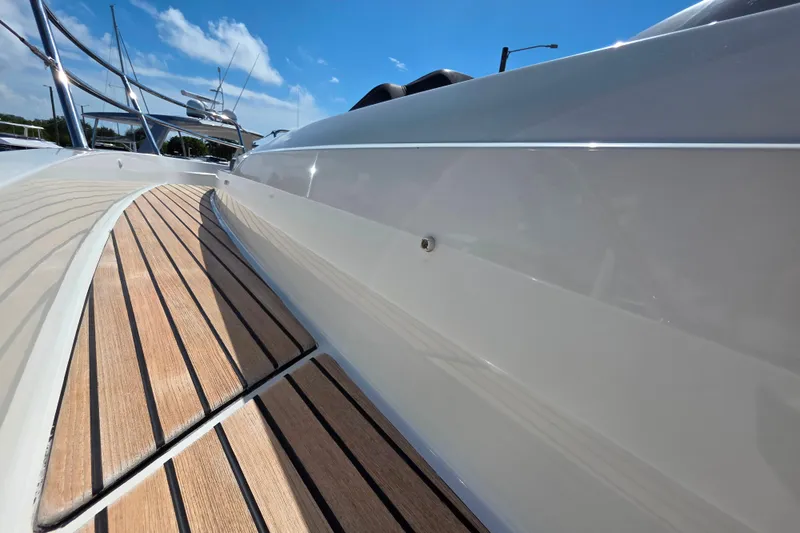 Slide: The Image of Wooden steps inside a 2021 Jeanneau Leader 10.5 WA boat, with sunlight casting shadows. - 36