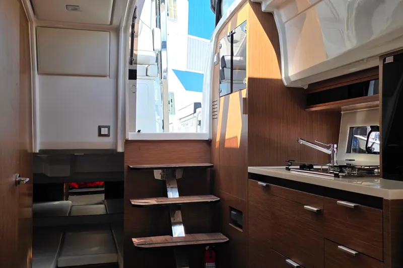 Slide: The Image of Interior cabin of 2021 Jeanneau Leader 10.5 WA with white cushions and wood paneling. - 38
