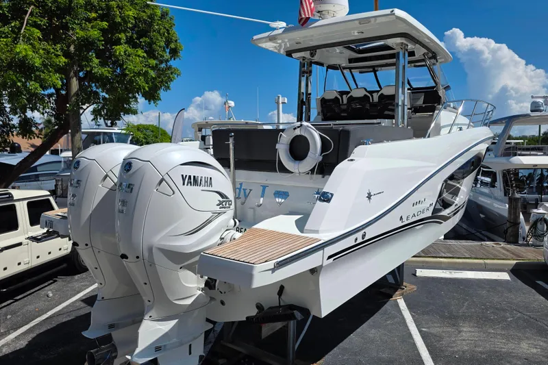 Slide: The Image of 2021 Jeanneau Leader 10.5 WA boat displayed outdoors under clear blue sky. - 4