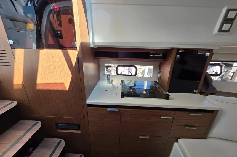 Slide: The Image of Interior of 2021 Jeanneau Leader 10.5 WA with modern kitchen and cozy seating area. - 40