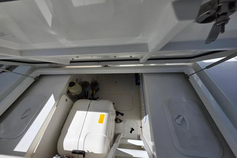 Slide: The Image of 2021 Jeanneau Leader 10.5 WA boat with Yamaha engines, displayed outdoors under clear blue sky. - 47