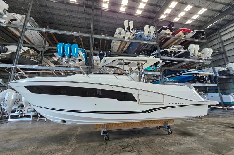 Slide: The Image of 2021 Jeanneau Leader 10.5 WA boat in storage facility with other vessels. - 50