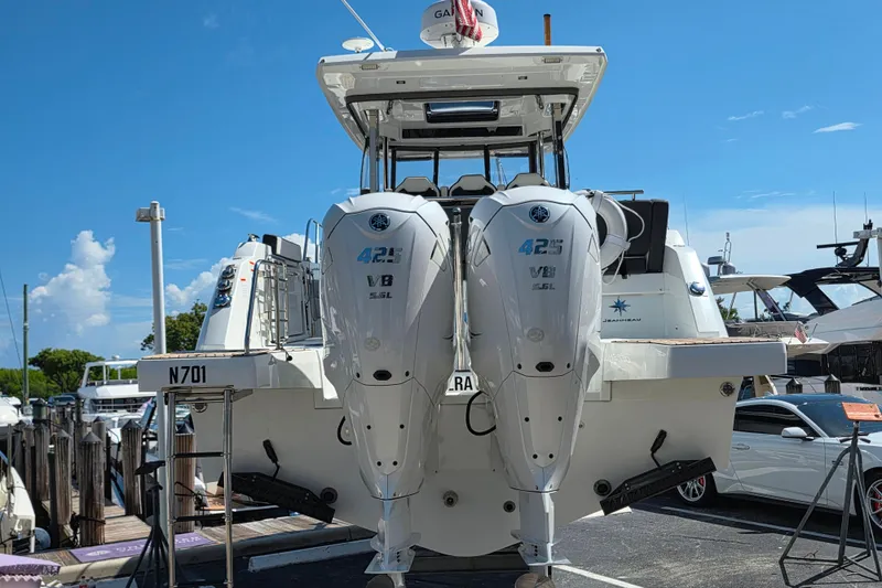 Slide: The Image of 2021 Jeanneau Leader 10.5 WA boat with dual 425 V8 engines at a marina. - 7