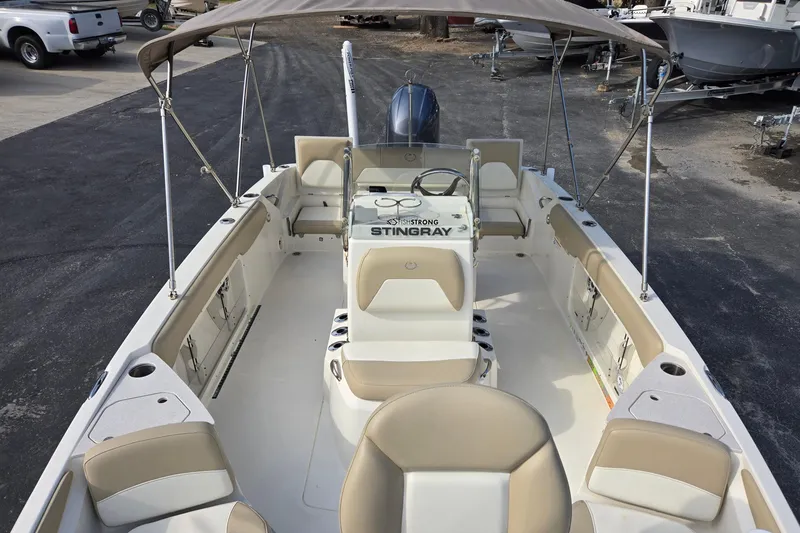 Slide: The Image of 2017 Stingray 206cc boat interior with seating and steering console. - 10