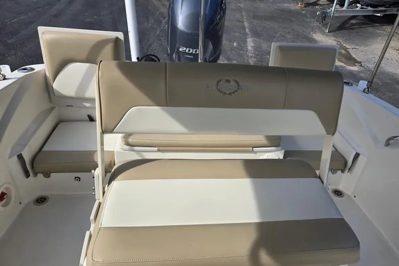 Slide: The Image of 2017 Stingray 206cc boat interior with beige and white seating. - 12