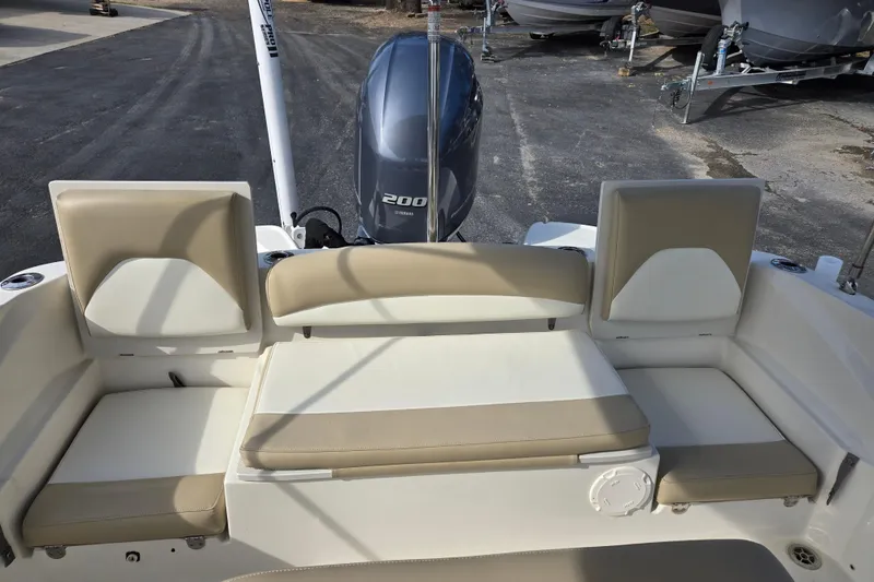Slide: The Image of 2017 Stingray 206cc boat interior with beige seating and Yamaha 200 engine. - 13