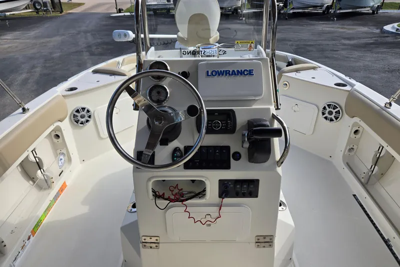 Slide: The Image of 2017 Stingray 206cc boat cockpit with steering wheel and Lowrance navigation system. - 14