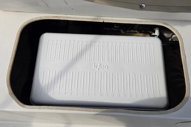 Slide: The Image of Built-in Igloo cooler in 2017 Stingray 206cc boat compartment. - 19