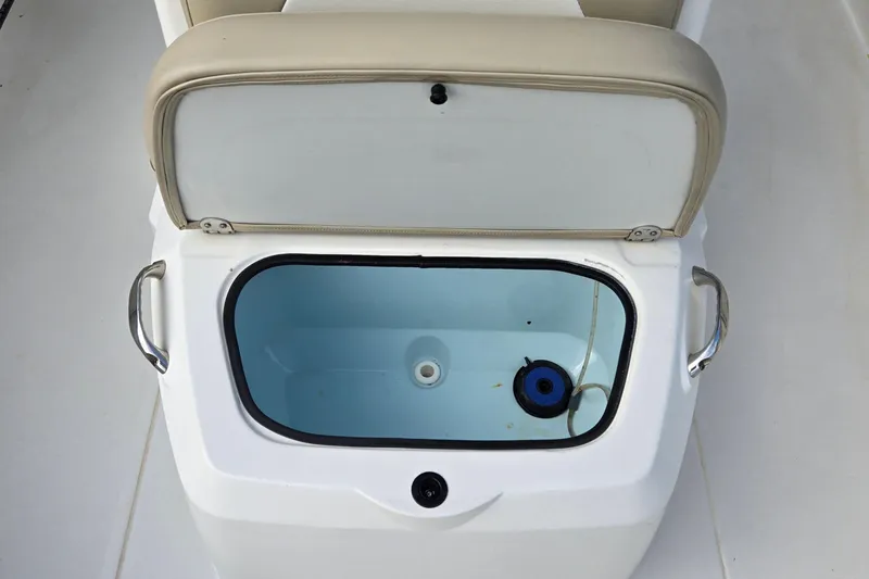 Slide: The Image of 2017 Stingray 206cc boat livewell with open lid and beige seat cushion. - 20