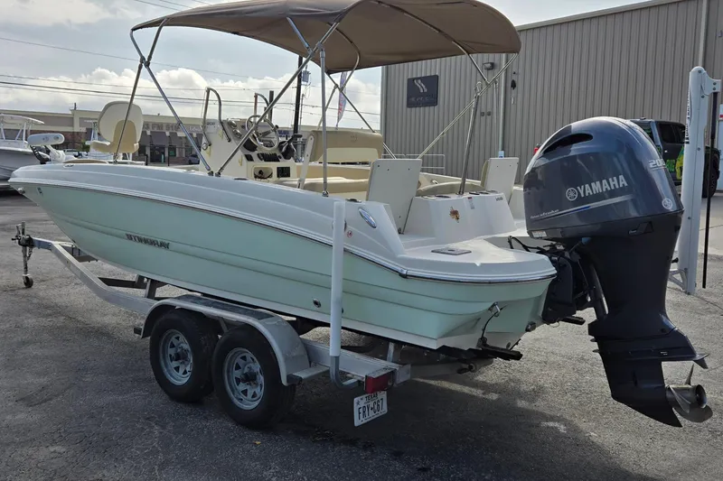 Slide: The Image of 2017 Stingray 206cc boat with Yamaha outboard motor on a trailer. - 5