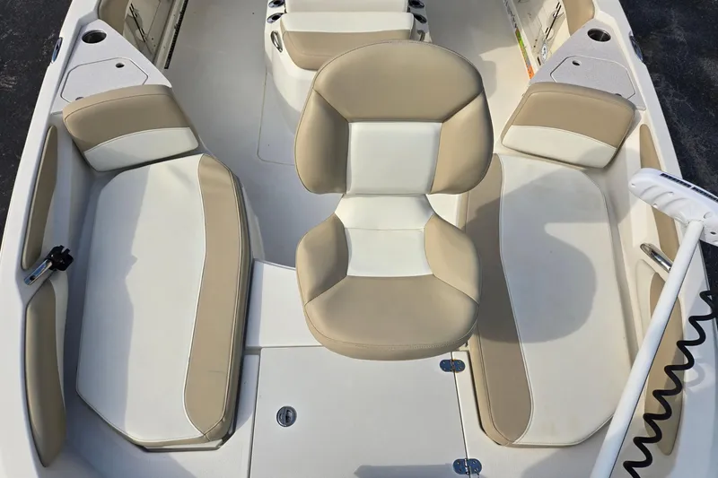 Slide: The Image of 2017 Stingray 206cc boat interior with beige and white seating arrangement. - 9