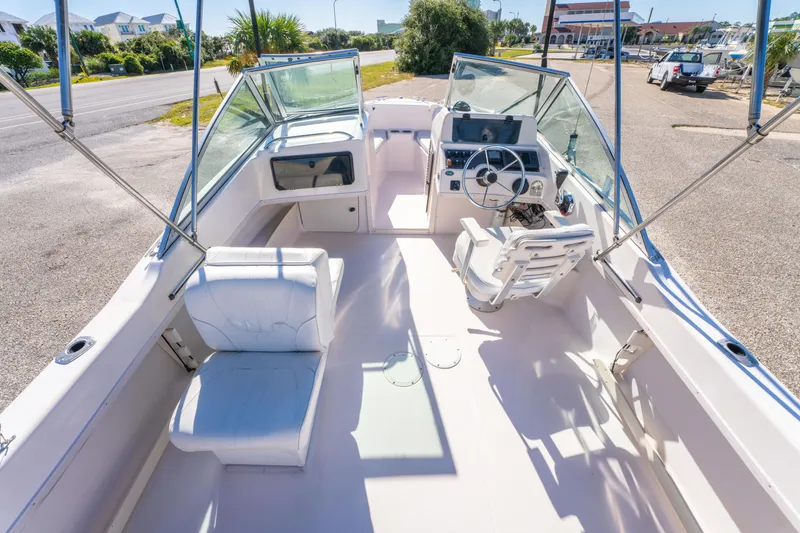 Slide: The Image of 1999 Grady-White Tournament 192 boat interior with seating and steering console. - 10