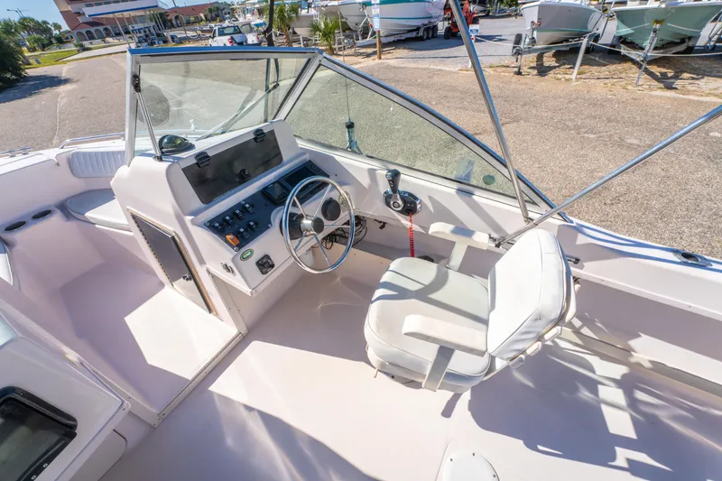 Slide: The Image of 1999 Grady-White Tournament 192 boat interior with steering wheel and control panel. - 12