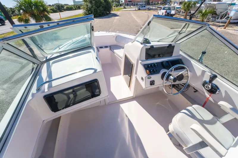 Slide: The Image of 1999 Grady-White Tournament 192 boat interior with steering wheel and seating area. - 13