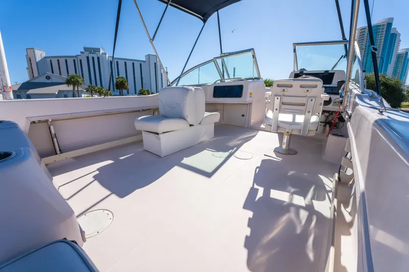 Slide: The Image of 1999 Grady-White Tournament 192 boat interior with seating and steering console. - 14