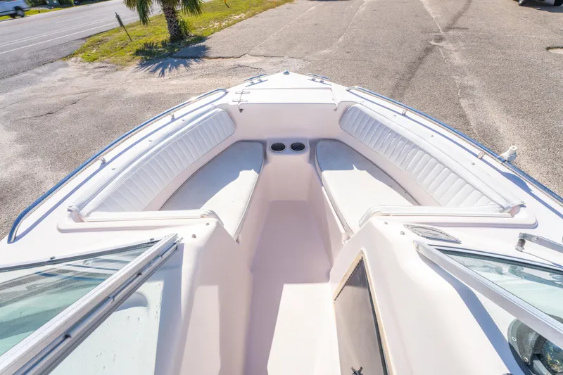 Slide: The Image of 1999 Grady-White Tournament 192 boat interior with white seating and cup holders. - 15