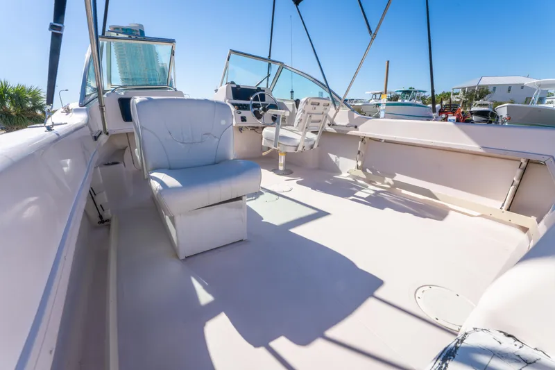 Slide: The Image of 1999 Grady-White Tournament 192 boat interior with seating and steering console. - 16